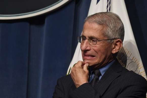 Dr. Anthony Fauci, right, director of the National Institute of Allergy and Infectious Diseases, listens during a news conference with members of the Coronavirus Task Force at the Department of Health ...