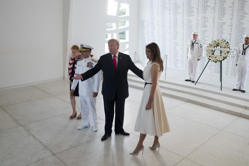U.S. President Donald Trump and first lady Melania Trump, accompanied by Command Commander Adm. Harry Harris, second from left, and his wife Bruni Bradley, left, depart after participating in a wreath ...