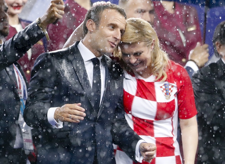 French President Emmanuel Macron and Croatian President Kolinda Grabar-Kitarovic, right, attend the award ceremony at the end of the final match between France and Croatia at the 2018 soccer World Cup ...