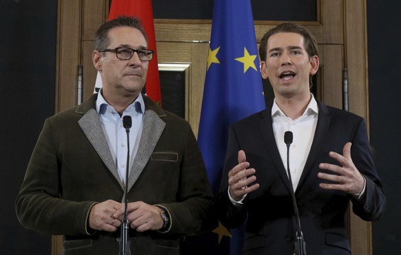 Heinz-Christian Strache, left, chairman of the right-wing Freedom Party, FPOE, listens as Foreign Minister and leader of the Austrian People&#039;s Party, OEVP, Sebastian Kurz, speaks at a joint press ...