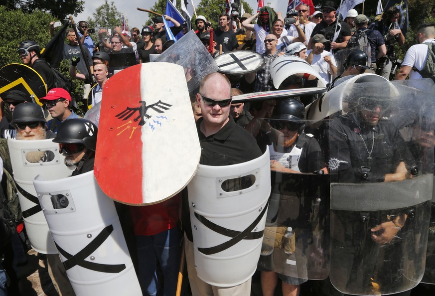 FILE - In this Aug. 12, 2017 file photo, white nationalist demonstrators use shields as they guard the entrance to Lee Park in Charlottesville, Va. The American Civil Liberties Union is reeling from c ...