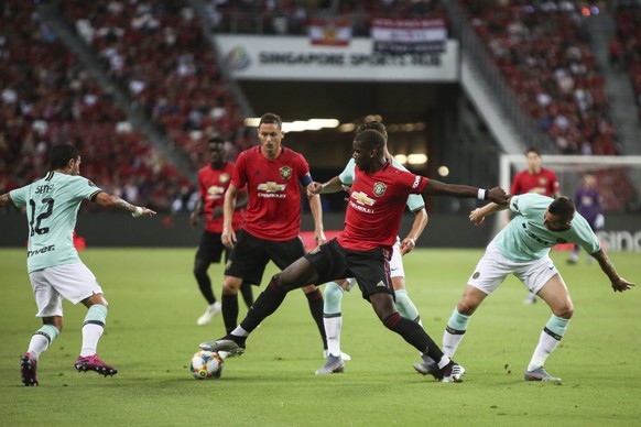 Manchester United&#039;s Paul Pogba, centre, in action during the match during the International Champions Cup soccer match between Manchester United and Milan in Singapore, Saturday, July 20, 2019. ( ...