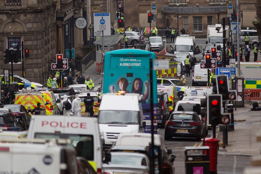 epa08510907 Police and emergency responders attend the scene of a stabbing incident in downtown Glasgow, Scotland, Britain, 26 June 2020. According to media reports, police have shot an attacker who h ...