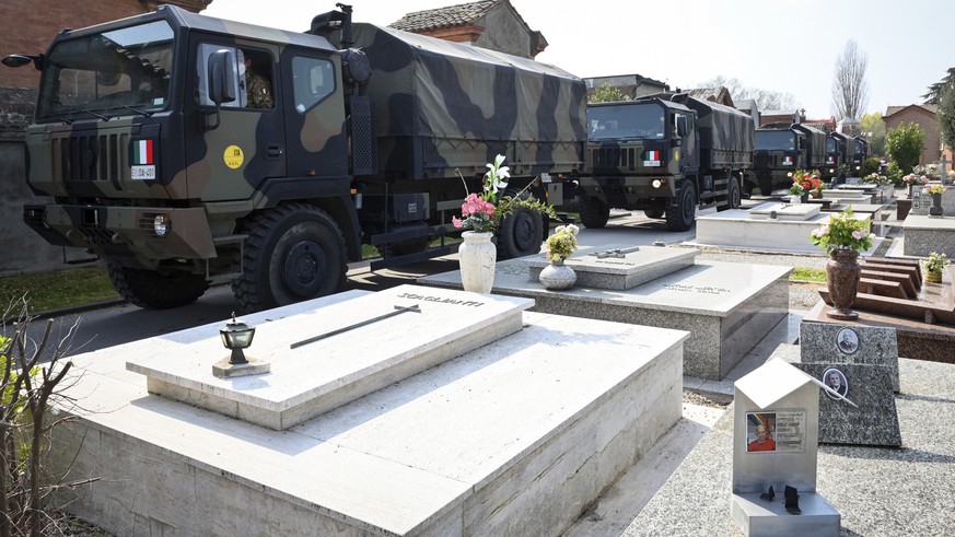 A convoy of Italian Army trucks arrives from Bergamo carrying bodies of coronavirus victims to the cemetery of Ferrara, Italy, where they will be cremated, Saturday, March 21, 2020. The transfer was m ...