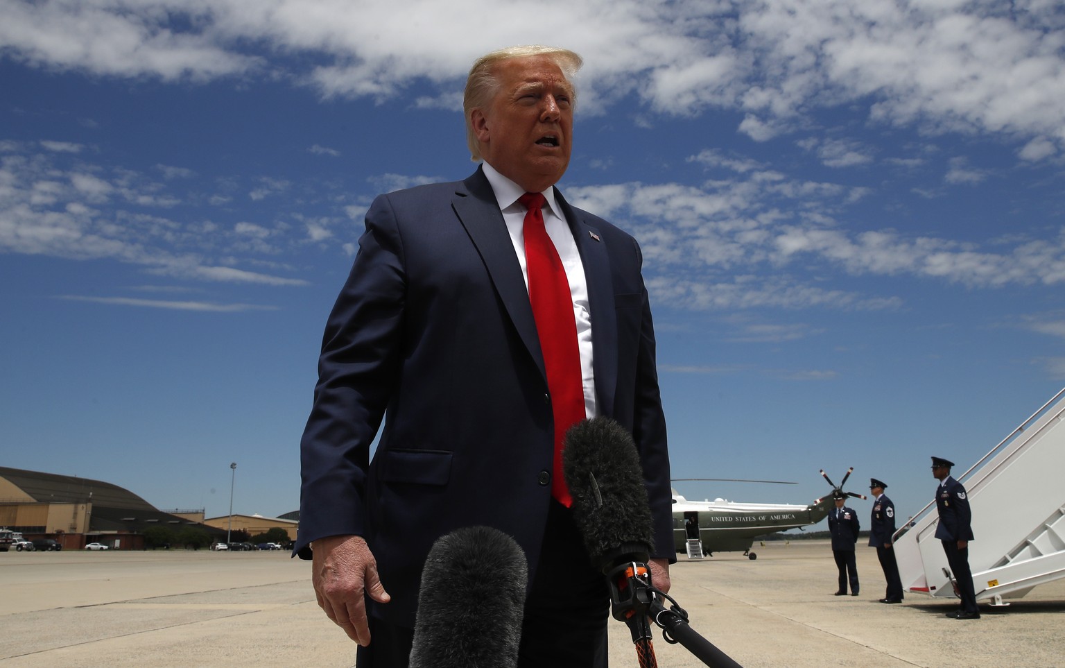 President Donald Trump speaks to the media as boards Air Force One, Saturday, May 30, 2020, at Andrews Air Force Base, Md. Trump is en route to Kennedy Space Center for the SpaceX Falcon 9 Launch. (AP ...