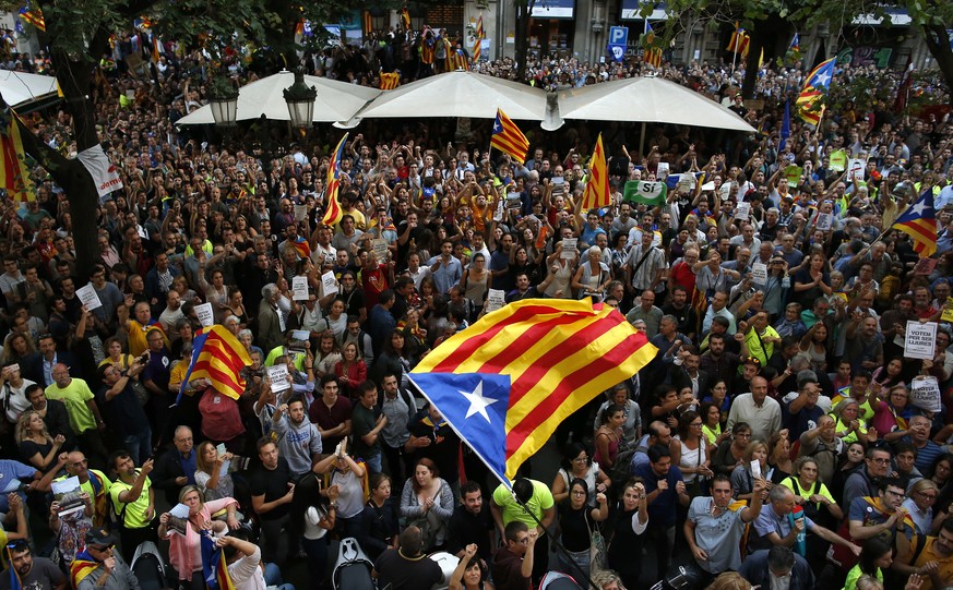 A crowd of protestors gather outside the Catalan region&#039;s economy ministry building in Barcelona, Spain, Wednesday, Sept. 20, 2017. The Catalan regional government says that a top official in the ...