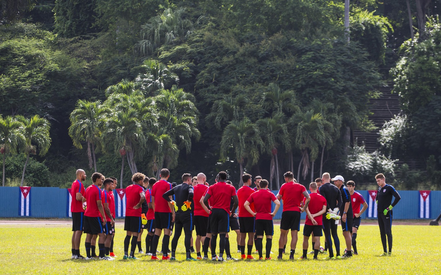 The United States national soccer team coach Jurgen Klinsmann, at right with white cap, gives instructions to his players during a training session at Pedro Marrero Stadium in Havana, Cuba, Thursday,  ...