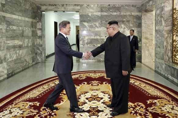 In this May 26, 2018 photo provided on May 27, 2018, by South Korea Presidential Blue House via Yonhap News Agency, North Korean leader Kim Jong Un, right, and South Korean President Moon Jae-in, left ...
