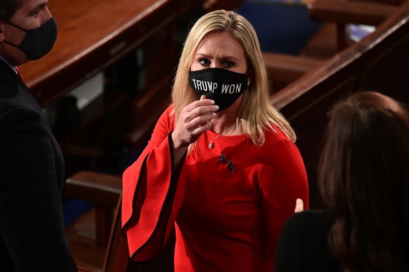 FILE - In this Sunday, Jan. 3, 2021, file photo, Rep. Marjorie Taylor Greene, R-Ga., wears a &quot;Trump Won&quot; face mask as she arrives on the floor of the House to take her oath of office on open ...