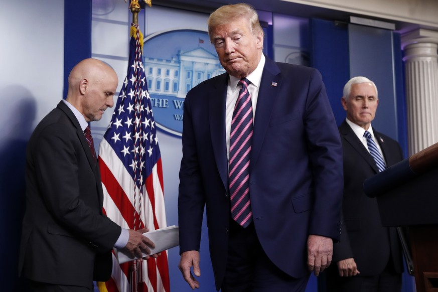 President Donald Trump steps away from the podium to allow Stephen Hahn, commissioner of the U.S. Food and Drug Administration, to speaks about the coronavirus in the James Brady Press Briefing Room o ...