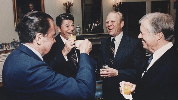 Photograph of the Four Presidents (Reagan, Carter, Ford, Nixon) toasting in the Blue Room prior to leaving for Egypt... - NARA - 198522