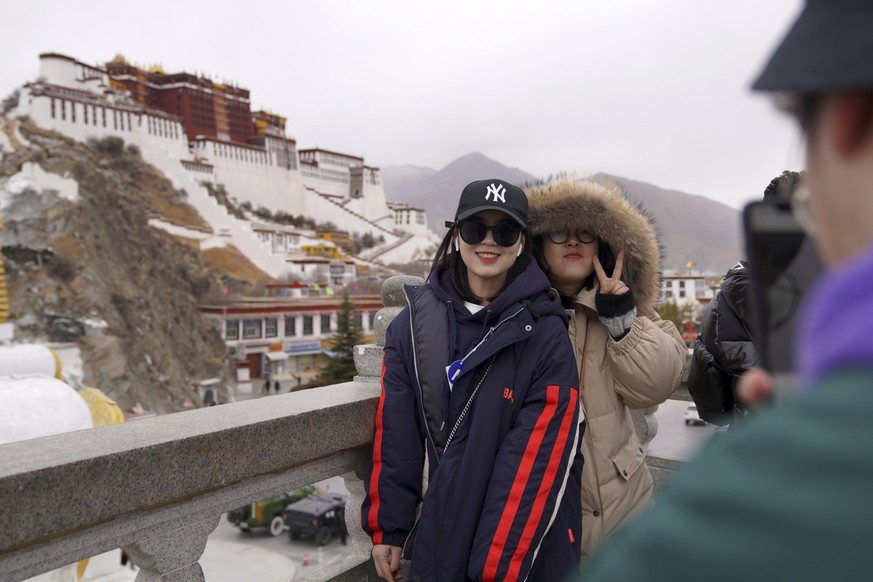In this Feb. 9, 2019, photo released by Xinhua News Agency, tourists pose for souvenir photos in front of the Potala Palace in Lhasa, southwest China&#039;s Tibet Autonomous Region. China is barring f ...