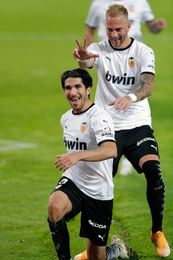 epa08808870 Valencia&#039;s midfielder Carlos Soler (L) celebrates with teammates after scoring a goal during the Spanish La Liga soccer match between Valencia CF and Real Madrid at Mestalla stadium i ...