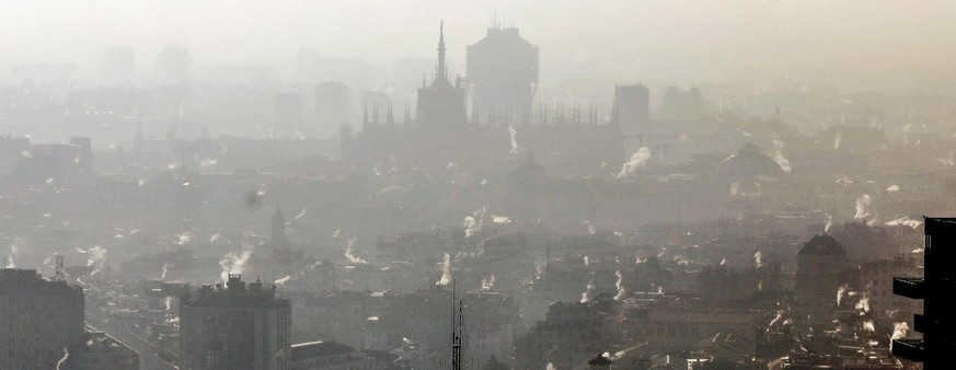 epa08112396 Smog hangs over Milan, Italy, 08 January 2020. According to reports, the Region of Lombardy closed traffic in the cities as Milan, for the most polluting cars, including standards of euro  ...