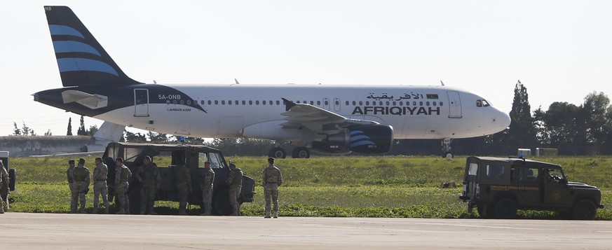 Maltese troops survey a hijacked Libyan Afriqiyah Airways Airbus A320 on the runway at Malta Airport, December 23, 2016. REUTERS/Darrin Zamit-Lupi MALTA OUT