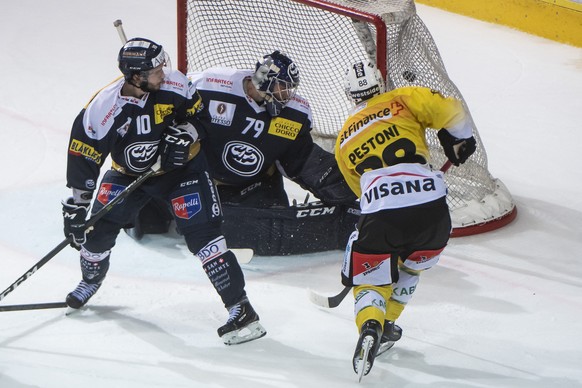From right, Bern&#039;s player Inti Pestoni, scores the 1:3 against Ambri&#039;s goalkeeper Daniel Manzato and Ambri&#039;s player Bryan Flynn, during the preliminary round game of National League A ( ...