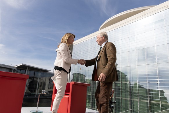 epa07844527 German journalist Tina Hassel (L) and Federal co-chairman of the Alternative for Germany (AfD) right-wing populist party Alexander Gauland (R) shake hands during the traditional summer int ...