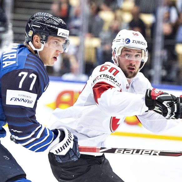 epa06745574 Markus Nutivaara of Finland and Tristan Scherwey of Switzerland during the IIHF World Championship quarter finals match between Finland and Switzerland at Jyske Bank Boxen in Herning, Denm ...