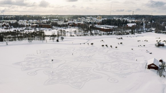 The complex geometric pattern formed from thousands of footsteps in the snow in Espoo, Finland, Monday Feb. 8, 2021. The art work design measuring about 160 meters in diameter was made by volunteers i ...