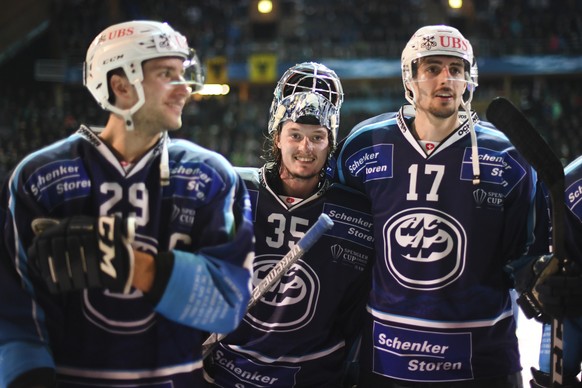 Ambri&#039;s Michael Foram goalkeeper Ludovic Waeber, and Ambri&#039;s Igor Jelovac, from left, after the game between HC Ambri-Piotta and TPS Turku, at the 93th Spengler Cup ice hockey tournament in  ...