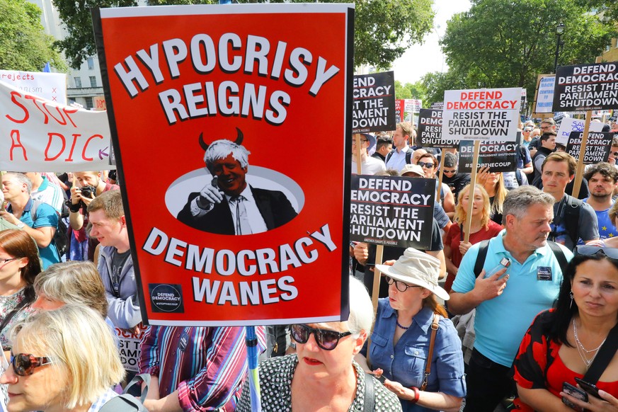 epa07806913 Anti Brexit protesters with a banner &#039;Hypcrisy Reigns, Democracy Wanes&#039; outside Downing Street in Whitehall during a protest against Brexit and the prorogation of parliament in L ...