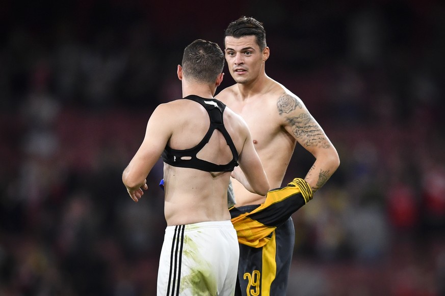 Arsenals Granit Xhaka, right, and brother Taulant Xhaka of Basel switch shirts, after an UEFA Champions League Group stage Group A matchday 2 soccer match between England&#039;s Arsenal FC and Switzer ...