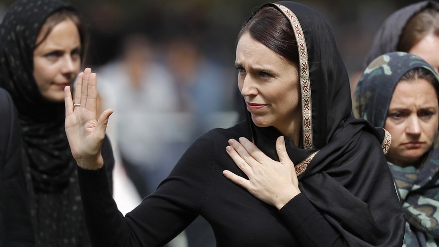 New Zealand Prime Minister Jacinda Ardern, center, waves as she leaves Friday prayers at Hagley Park in Christchurch, New Zealand, Friday, March 22, 2019. People across New Zealand are observing the M ...