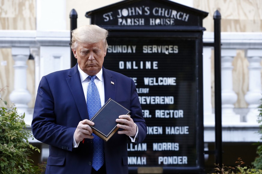 FILE - In this June 1, 2020, file photo, President Donald Trump holds a Bible as he visits outside St. John&#039;s Church across Lafayette Park from the White House in Washington. Trump began June wit ...