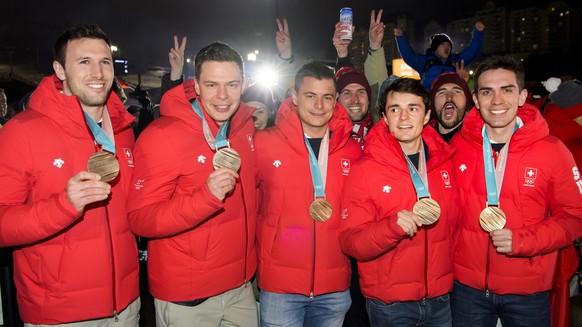 SwitzerlandÕs Curling Bronze medal winners, Dominik Maerki,Claudio Paetz, Valentin Tanner, Benoit Schwarz, and Peter de Cruz, from left to right, celebrate at the House of Switzerland after the women  ...