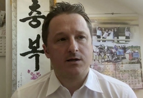 FILE - In this March 2, 2017, file image made from video, Michael Spavor, director of Paektu Cultural Exchange, talks during a Skype interview in Yanji, China. China has charged two detained Canadians ...