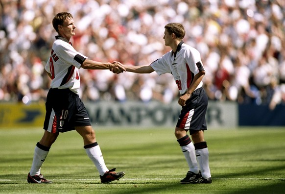 15 Jun 1998: Teddy Sheringham of England makes way for substitute Michael Owen (right) during the World Cup group G game against Tunisia at the Stade Velodrome in Marseille, France. England won 2-0. \ ...
