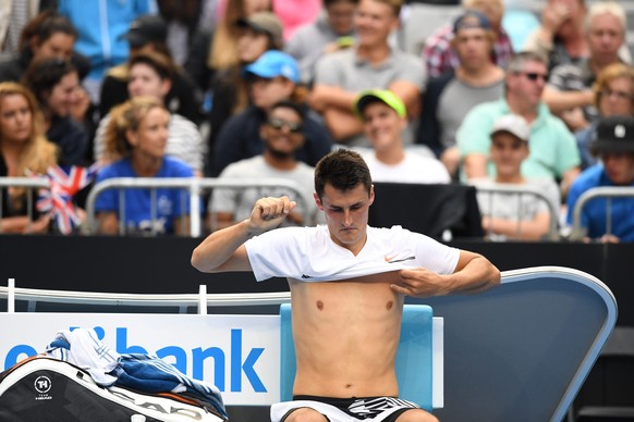 epa05733364 Bernard Tomic of Australia changes his shirt during the Mens Singles match against Daniel Evans of Great Britain in round 3 on day five of the Australian Open, in Melbourne, Australia, 20  ...