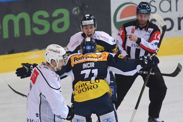 Ambri&#039;s player Elia Mazzolini celebrates the 2-0 goal, BACK, fight for the puck with Patrick Incir, front, during the preliminary round game of National League A (NLA) Swiss Championship 2019/20  ...