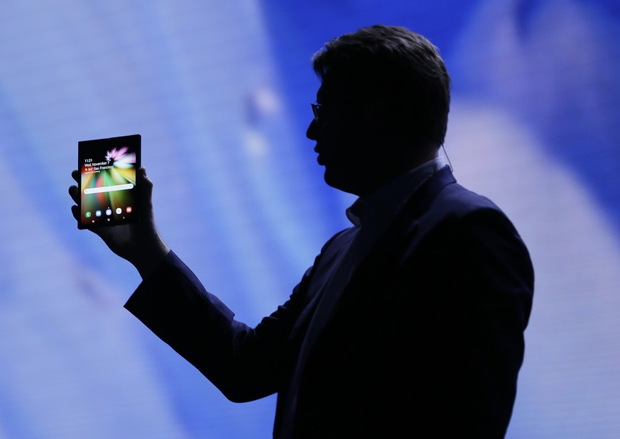 Justin Denison, SVP of Mobile Product Development, shows off the Infinity Flex Display of a folding smartphone during the keynote address of the Samsung Developer Conference, Wednesday, Nov. 7, 2018,  ...