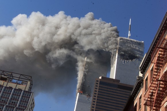 FILE - In this Sept. 11, 2001, file photo, smoke rises from the burning twin towers of the World Trade Center after hijacked planes crashed into the towers, in New York City. The coronavirus pandemic  ...