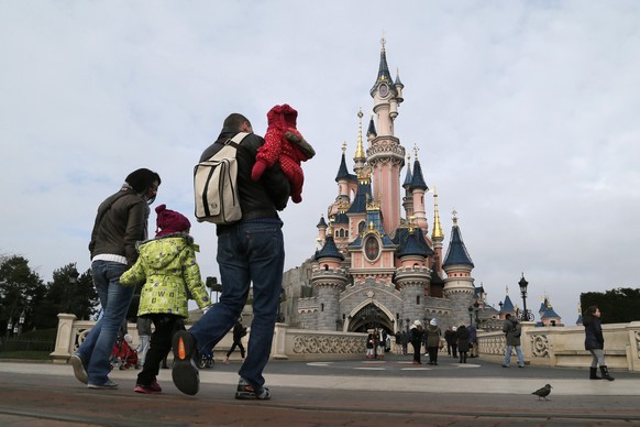 Visitors walk towards the Sleeping Beauty Castle during a visit to the Disneyland Paris Resort run by EuroDisney S.C.A in Marne-la-Vallee January 21, 2015. Picture taken January 21, 2015. To match Spe ...