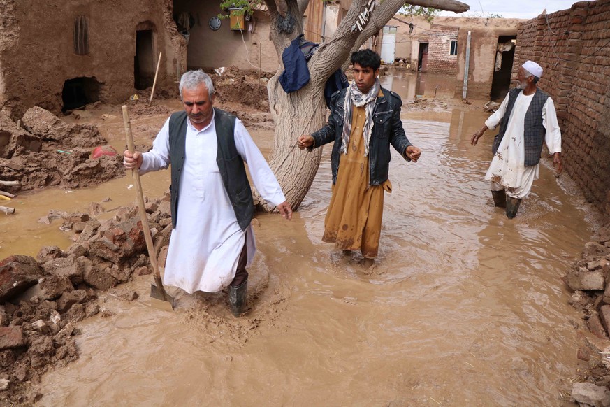epa07470695 Afghan people affected by seasonal floods salvage their belongings from damaged houses in Herat, Afghanistan, 29 April 2019. According to local reports, at least 24 villagers were killed w ...