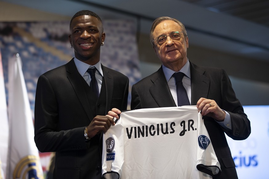 Brazilian soccer player Vinicius Jr, left, and Real Madrid President Florentino Perez pose for the media during his official presentation for Real Madrid at the Santiago Bernabeu stadium in Madrid, Sp ...
