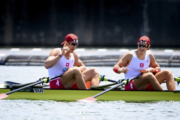 Swiss rowers Barnabe Delarze and Roman Roeoesli react after crossing the finish line in the men&#039;s rowing double sculls heat at the 2020 Tokyo Summer Olympics in Tokyo, Japan, on Friday, July 23,  ...
