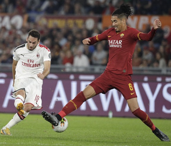 AC Milan&#039;s Hakan Calhanoglu, left, and Roma&#039;s Chris Smalling fight for the ball during a Serie A soccer match between Roma and AC Milan, at Rome&#039;s Olympic Stadium, Sunday, Oct. 27, 2019 ...