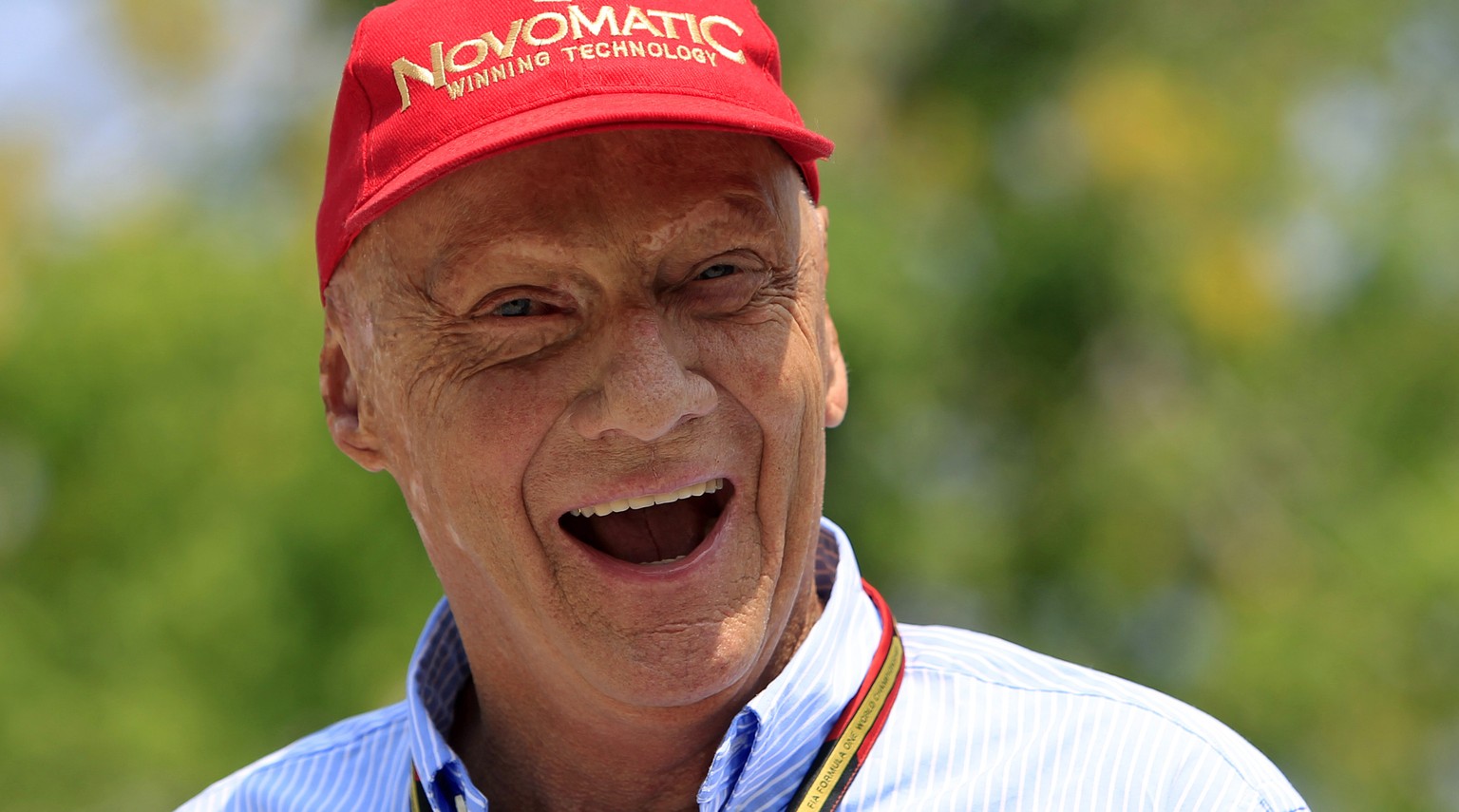 Former Formula One driver Niki Lauda of Austria laughs as he arrives at the paddock before the Malaysian Formula One Grand Prix at Sepang International Circuit in Sepang, Malaysia, Sunday, March 30, 2 ...