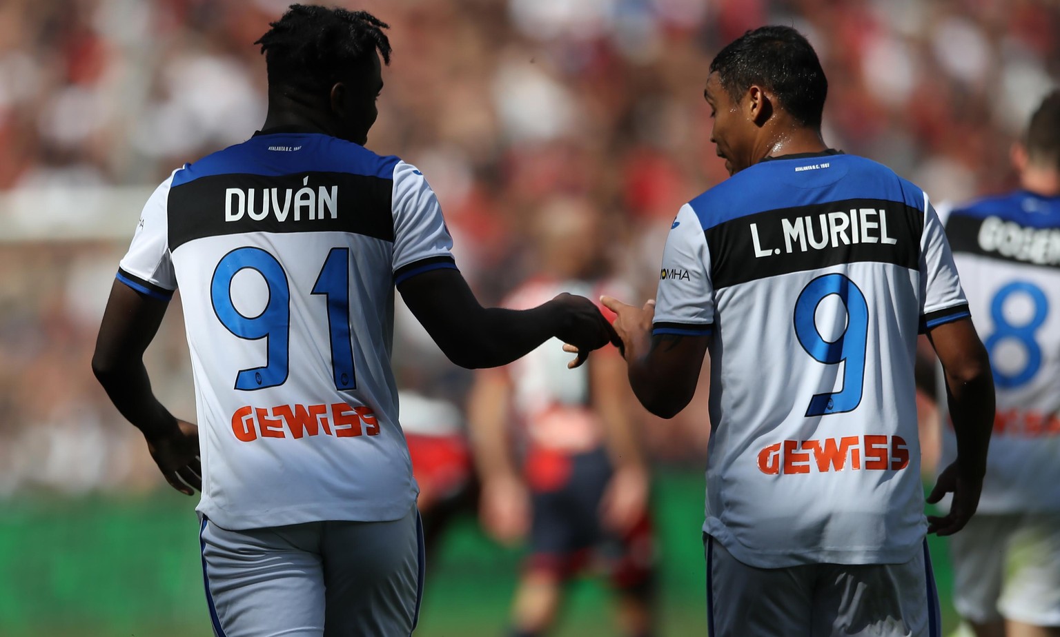 Duvan Zapata of Atalanta celebrates with team mate Luis Muriel after scoring to give the side a 2-1 lead in the 90th minute during the Serie A match at Stadio Luigi Ferraris, Genoa. Picture date: 15th ...