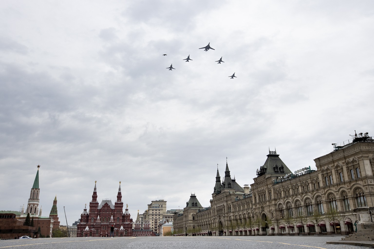 Russia&#039;s Air Force strategic bombers, Tu-160, right, and Tu-22M3, all others, fly over almost empty Red Square in Moscow, Russia, Monday, May 4, 2020. The Russian air force conducted a rehearsal  ...