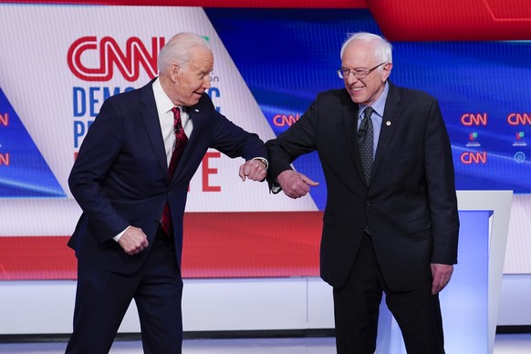 FILE - In this March 15, 2020, file photo, former Vice President Joe Biden, left, and Sen. Bernie Sanders, I-Vt., right, greet one another before they participate in a Democratic presidential primary  ...