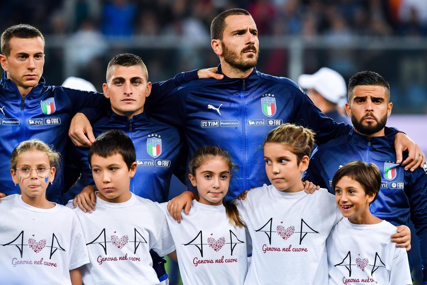 From left, Italy&#039;s Federico Bernardeschi, Marco Verratti, Leonardo Bonucci and Lorenzo Insigne line up as children wear shirts reading &quot;Genoa in our heart&quot;, an homage to the 43 victims  ...