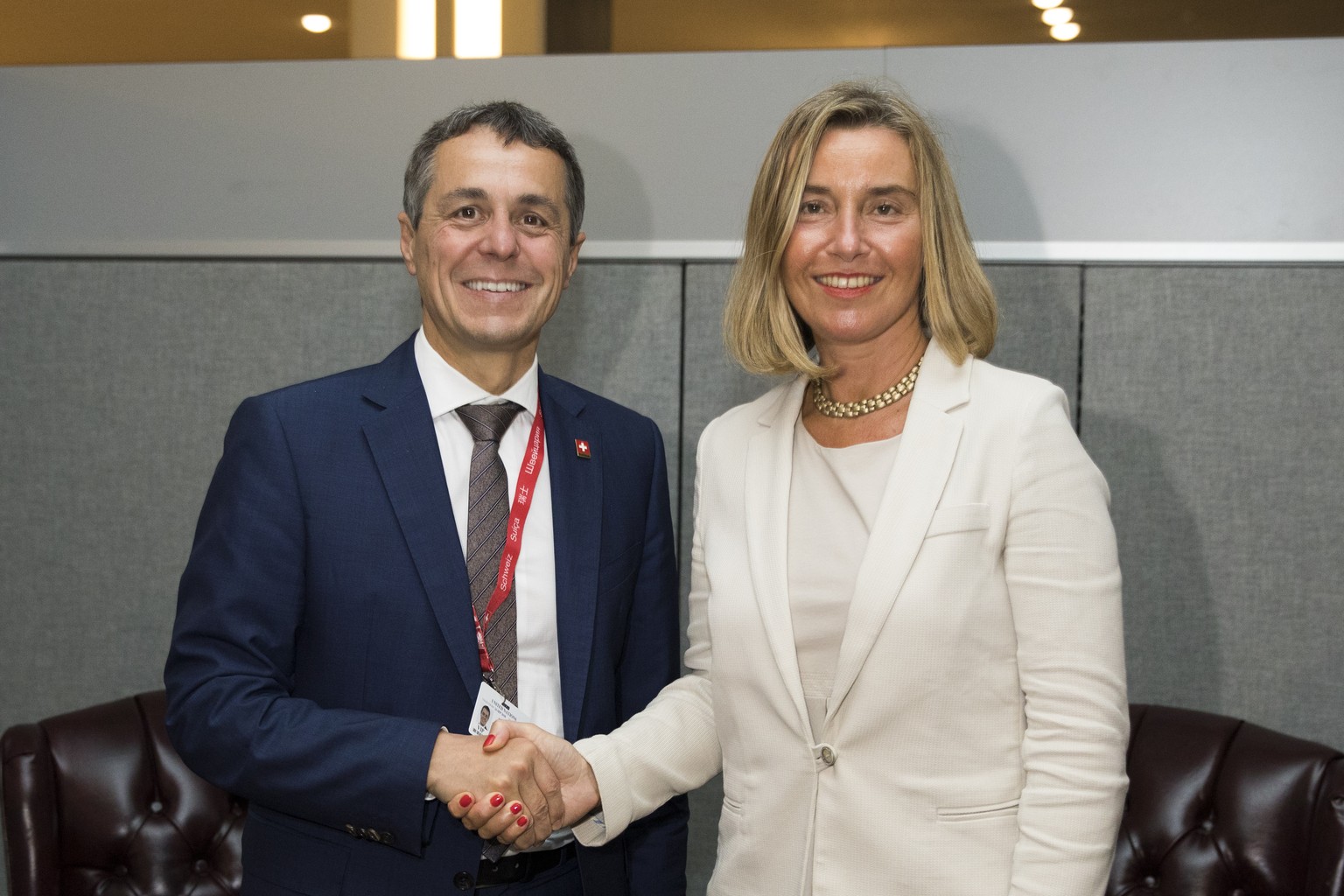 Swiss Foreign Minister Ignazio Cassis, left, and Federica Mogherini, European Union&#039;s High Representative for Foreign Affairs and Security Policy, right, shake hands during a bilateral meeting at ...