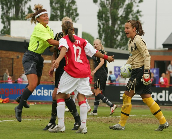 LONDON - APRIL 29: Referee Nicole Petignat jumps in to brake up a argument between Johanna Frisk of Umea IK and Alex Scott of Arsenal during the Womens UEFA Cup Final 2nd Leg match between Arsenal and ...