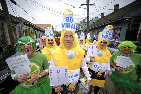 Revelers dressed in coronavirus costumes march in the St. Anne parade through the Marigny on Mardi Gras Day in New Orleans, La. Tuesday, Feb. 25, 2020. (Max Becherer/The Advocate via AP)