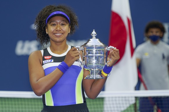 FILE - In this Sept. 12, 2020, file photo, Naomi Osaka, of Japan, holds up the championship trophy after defeating Victoria Azarenka, of Belarus, in the women&#039;s singles final of the US Open tenni ...