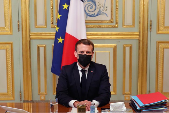epa08784029 French President Emmanuel Macron attends a video conference call about the coronavirus outbreak with members of the European Council, at the Elysee Palace in Paris, France, 29 October 2020 ...